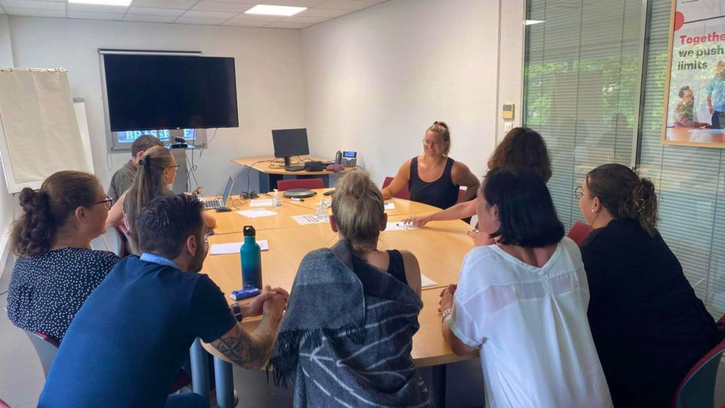 group of people sitting in a meeting