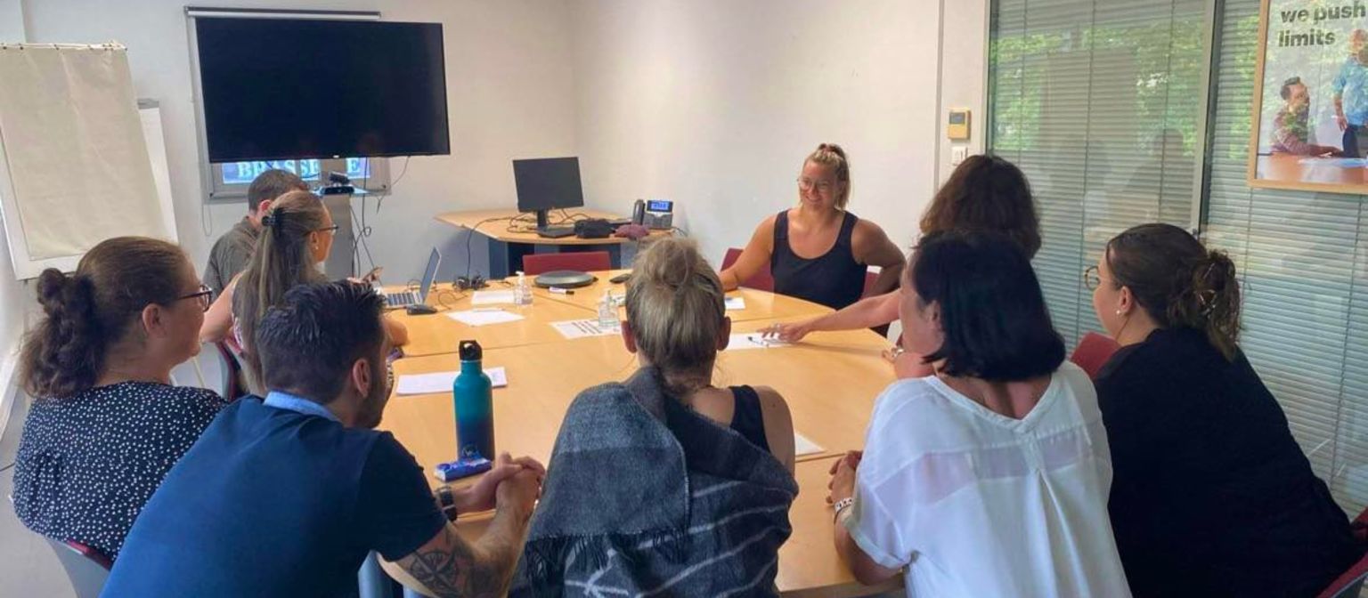 group of people sitting in a meeting